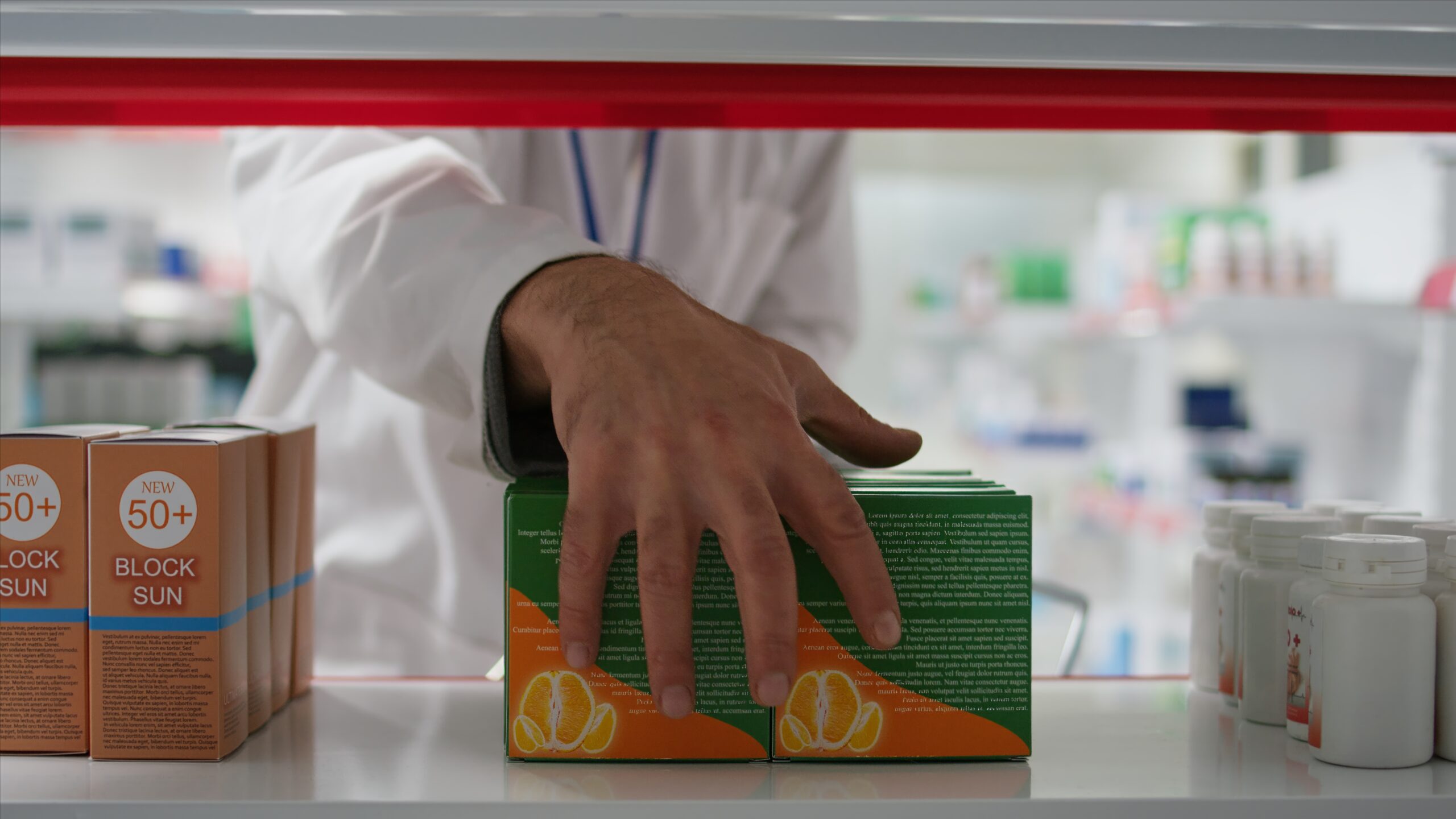 Retail employee emptying racks for products reorganization, taking all medicaments and vitamins in a basket. Seller working on restocking medical products and pharmaceutical supplies. Tripod shot.